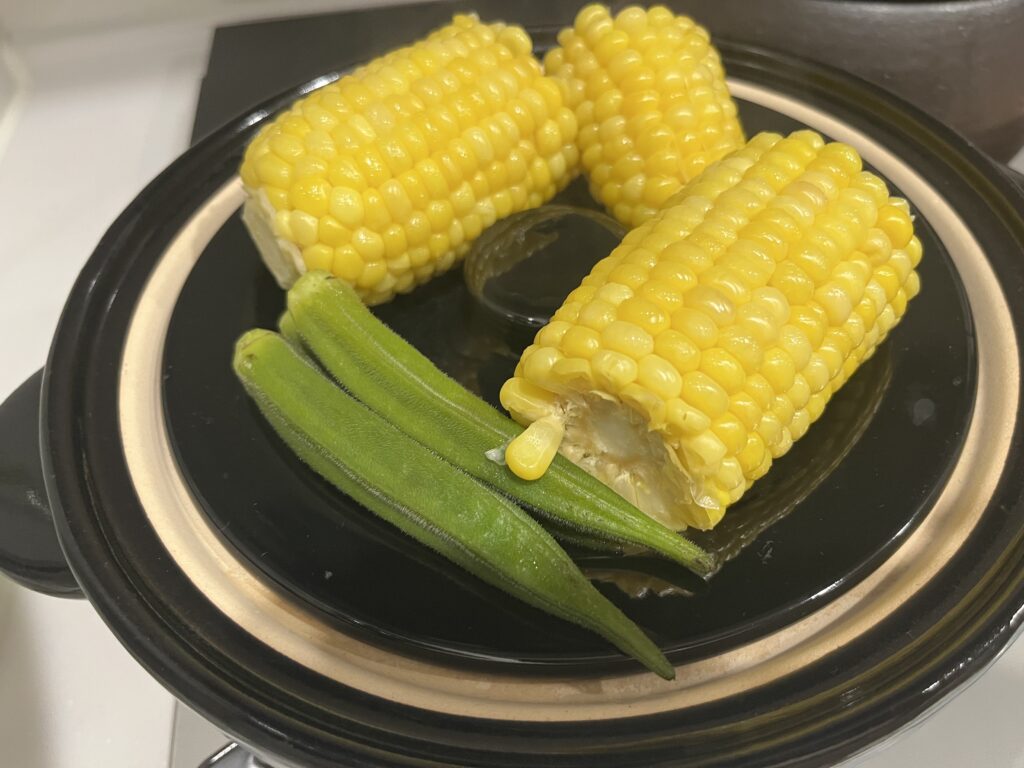 かまどさんで炊飯中に蒸し野菜を作る写真